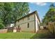 Exterior view of a two-story home with a backyard deck, fenced yard, and mature trees at 2156 Doris Dr, Decatur, GA 30034