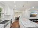 Open kitchen with an island, hardwood floors, stainless steel sink and appliances, and pendant lighting at 2156 Doris Dr, Decatur, GA 30034