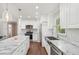 Bright kitchen with a large island, white cabinets, stainless steel appliances, and hardwood floors at 2156 Doris Dr, Decatur, GA 30034