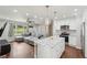 Open-concept view of living room and kitchen featuring quartz countertops, stainless steel appliances, and hardwood floors at 2156 Doris Dr, Decatur, GA 30034
