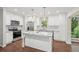 Bright, modern kitchen with white cabinetry, stainless steel appliances, granite countertops, and hardwood floors at 2156 Doris Dr, Decatur, GA 30034