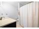 Bright bathroom with a vanity, toilet, and a shower behind a light-colored shower curtain at 807 Woodcliff Dr, Sandy Springs, GA 30350