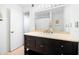 Bathroom boasts a stylish dark vanity and a well-lit mirror with a shower/tub combination in the background at 807 Woodcliff Dr, Sandy Springs, GA 30350