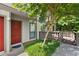 Townhome entrance featuring a red door, green shrubs, and a stone walkway leading up to the home at 807 Woodcliff Dr, Sandy Springs, GA 30350