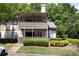 Two-story condo with double decks and steps leading up to a well-manicured lawn and mature trees at 807 Woodcliff Dr, Sandy Springs, GA 30350