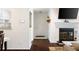 Inviting foyer with wood floors, a fireplace, a white door, and modern wall decor at 807 Woodcliff Dr, Sandy Springs, GA 30350