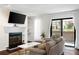Bright living room with fireplace, hardwood flooring and sliding doors to outside patio at 807 Woodcliff Dr, Sandy Springs, GA 30350