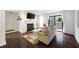 Cozy living room with dark wood floors, fireplace, sliding glass door, and comfortable furniture at 807 Woodcliff Dr, Sandy Springs, GA 30350