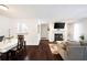 Open concept living room featuring hardwood floors, fireplace, kitchen access, and dining area at 807 Woodcliff Dr, Sandy Springs, GA 30350