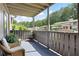 Relaxing covered patio featuring comfortable wicker chairs and serene views of the surrounding landscape at 807 Woodcliff Dr, Sandy Springs, GA 30350