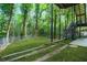 Large backyard with green lawn and stairs to a raised deck at 1810 Fairoaks Pl, Decatur, GA 30033