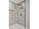 Shower with unique tile design, rainfall shower head, and glass enclosure at 1810 Fairoaks Pl, Decatur, GA 30033