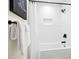 This renovated bathroom features modern fixtures, textured white walls, and a shower and tub at 1810 Fairoaks Pl, Decatur, GA 30033