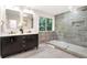 Modern bathroom featuring double vanity with sleek fixtures and large shower with unique tile work at 1810 Fairoaks Pl, Decatur, GA 30033