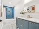 Bathroom featuring a modern vanity with gold fixtures and blue tiled shower at 1810 Fairoaks Pl, Decatur, GA 30033