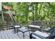 Relaxing deck area with wicker furniture and comfortable cushions, nestled in a wooded setting at 1810 Fairoaks Pl, Decatur, GA 30033