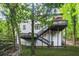 Exterior of a home showing a backyard, multi-level decks and stairs at 1810 Fairoaks Pl, Decatur, GA 30033