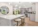 Modern kitchen featuring a large island with marble countertop and stylish bar stools at 1810 Fairoaks Pl, Decatur, GA 30033