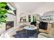 Open concept living room with modern fireplace, hardwood floors, and lots of light from large windows at 1810 Fairoaks Pl, Decatur, GA 30033