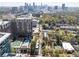 An aerial view of the property showcasing its proximity to a pool, lush trees, and a vibrant cityscape at 1821 Huntington Hills Nw Ln, Atlanta, GA 30309