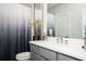 Modern bathroom with grey vanity, white countertop, contemporary sink, decorative plant, and a stylish shower curtain at 1821 Huntington Hills Nw Ln, Atlanta, GA 30309