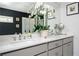 Modern bathroom featuring a quartz countertop, gray cabinets, dual sinks, and decorative lighting at 1821 Huntington Hills Nw Ln, Atlanta, GA 30309