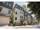 Attractive townhome with a garage and stylish white brick and dark accents at 1821 Huntington Hills Nw Ln, Atlanta, GA 30309
