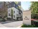 Modern townhome exterior featuring light brick, dark accents, and lush landscaping at 28th at Brookwood at 1821 Huntington Hills Nw Ln, Atlanta, GA 30309
