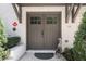 Welcoming double front doors with charming details, complemented by manicured greenery, enhancing curb appeal at 1821 Huntington Hills Nw Ln, Atlanta, GA 30309