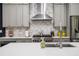 Modern kitchen with gray cabinetry, marble backsplash, stainless steel appliances, and a large island perfect for gathering at 1821 Huntington Hills Nw Ln, Atlanta, GA 30309