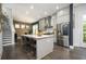 Open kitchen with an island featuring pendant lights, stainless steel appliances and fixtures, and wood flooring at 1821 Huntington Hills Nw Ln, Atlanta, GA 30309