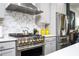 Modern kitchen with stainless steel appliances, stylish tile backsplash, and neutral cabinets at 1821 Huntington Hills Nw Ln, Atlanta, GA 30309