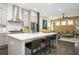 Modern kitchen boasts an island with bar seating, stainless steel appliances, and marble backsplash at 1821 Huntington Hills Nw Ln, Atlanta, GA 30309