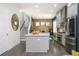 Open-concept kitchen with a center island, stainless steel appliances, and staircase to the upper level at 1821 Huntington Hills Nw Ln, Atlanta, GA 30309