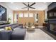 Stylish living room featuring a fireplace, ceiling fan, decorative wallpaper, and a comfortable gray sofa at 1821 Huntington Hills Nw Ln, Atlanta, GA 30309