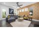Comfortable living room with patterned wallpaper, large gray couch, ceiling fan and decorative accents at 1821 Huntington Hills Nw Ln, Atlanta, GA 30309