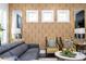 Living room with patterned wallpaper, large gray couch, ceiling fan, and decorative accents at 1821 Huntington Hills Nw Ln, Atlanta, GA 30309