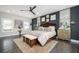 Spacious main bedroom with a seating area, a ceiling fan, natural light, and a decorative rug at 1821 Huntington Hills Nw Ln, Atlanta, GA 30309
