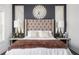 Stylish main bedroom featuring a tufted headboard, dark accent wall, and light filled windows at 1821 Huntington Hills Nw Ln, Atlanta, GA 30309