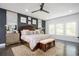 Spacious main bedroom with a seating area, a ceiling fan, natural light, and a decorative rug at 1821 Huntington Hills Nw Ln, Atlanta, GA 30309