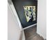 Staircase view with black accent wall with modern art and wood stairs at 1821 Huntington Hills Nw Ln, Atlanta, GA 30309