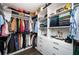 Walk-in closet with custom shelving, cabinets, and hanging rods to maximize storage space and organization at 1821 Huntington Hills Nw Ln, Atlanta, GA 30309