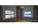 Cozy bedroom featuring two windows offering city views, light-filtering shades, and hardwood floors at 20 Marietta Nw St # 16A, Atlanta, GA 30303