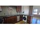 Compact kitchen with stainless steel appliances, dark countertops, and a combination washer/dryer unit at 20 Marietta Nw St # 16A, Atlanta, GA 30303
