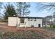 Backyard view of white brick home featuring a patio and covered porch at 3215 Pennignton Cir, Atlanta, GA 30354
