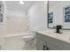 Bright bathroom features a shower-tub, white tile, gray vanity and black hardware at 3215 Pennignton Cir, Atlanta, GA 30354