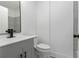 Modern bathroom featuring a gray vanity, black fixtures, and stone-look accent wall at 3215 Pennignton Cir, Atlanta, GA 30354