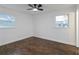 Inviting bedroom with wood floors, a ceiling fan, and two large windows with natural light at 3215 Pennignton Cir, Atlanta, GA 30354