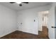 Cozy bedroom with hardwood floors, ceiling fan, and open door to the hallway at 3215 Pennignton Cir, Atlanta, GA 30354