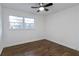 Bright bedroom with hardwood floors, ceiling fan, and large window with backyard view at 3215 Pennignton Cir, Atlanta, GA 30354